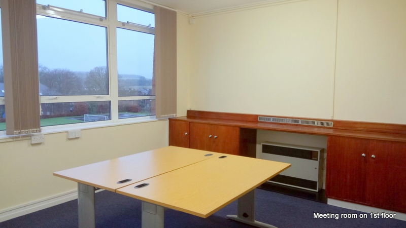 a meeting room containing a table with views over the recreation ground