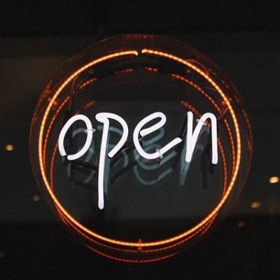 a neon sign reading OPEN