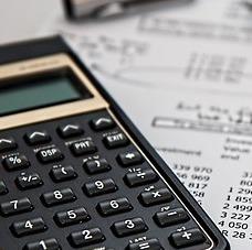 a calculator sits on top of papers with lots of numbers on them