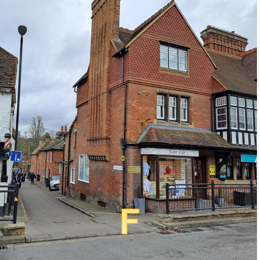 a street.  On the other side of the road there is a lane between buildings