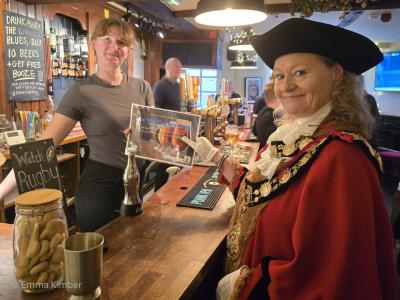 Two women each old one side of a document